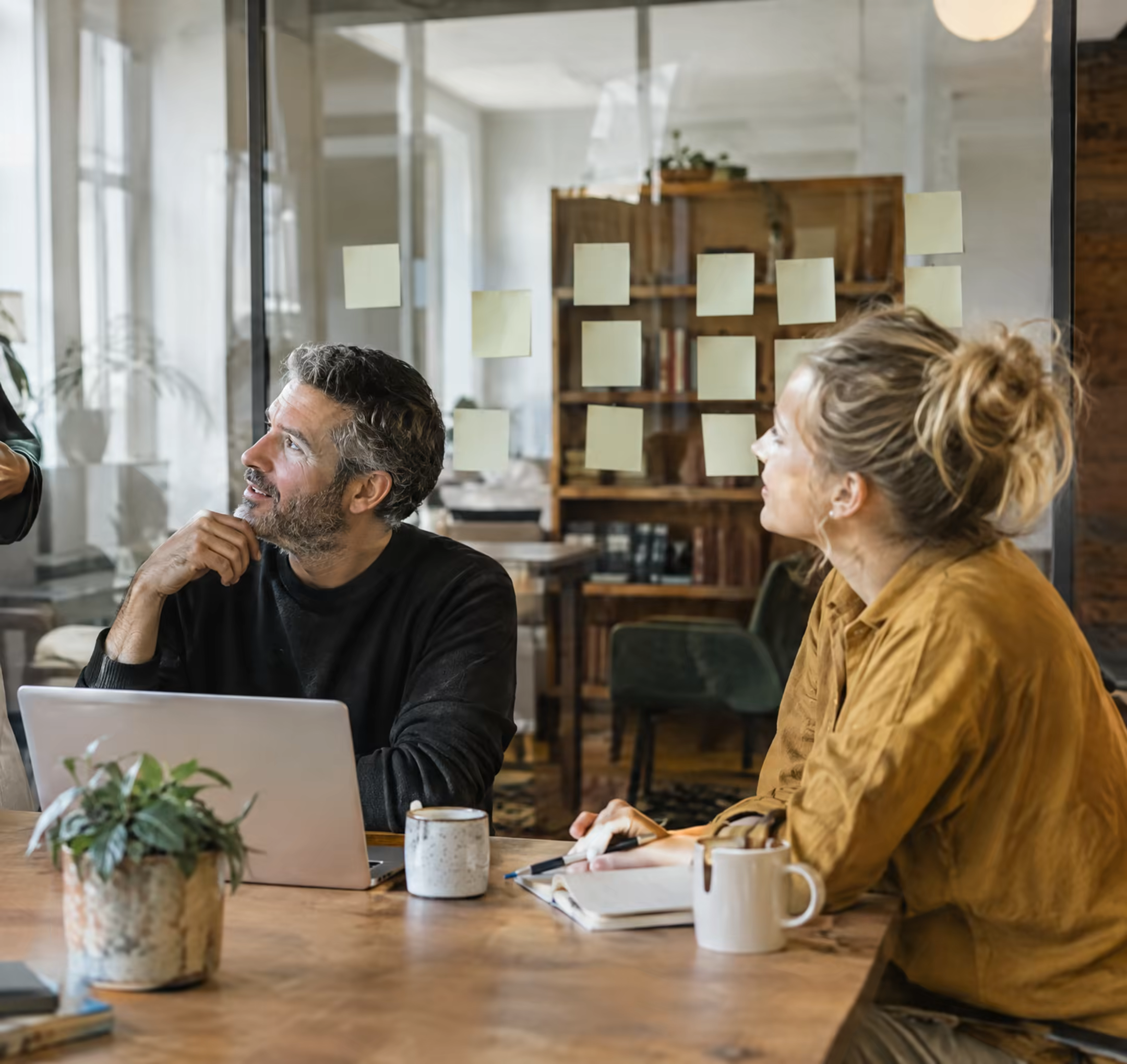 Colleagues in conversation in a bright studio office